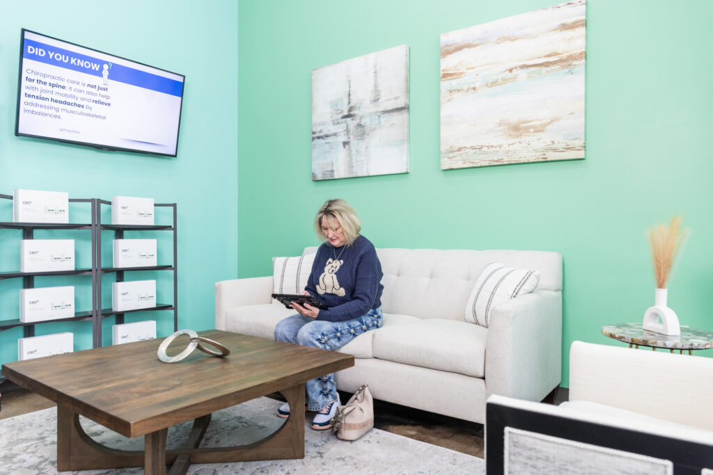 Woman sits in waiting area for her appointment to learn how to reduce inflammation in the body