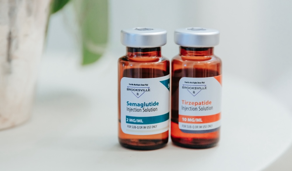 Two bottles labeled 'tirzepatide' and 'semaglutide' sit on a counter. Patients can visit Iowa Wellness Center for semaglutide near Cedar Rapids to start their weight loss journey using injectables that curb appetite and regulate blood sugar.